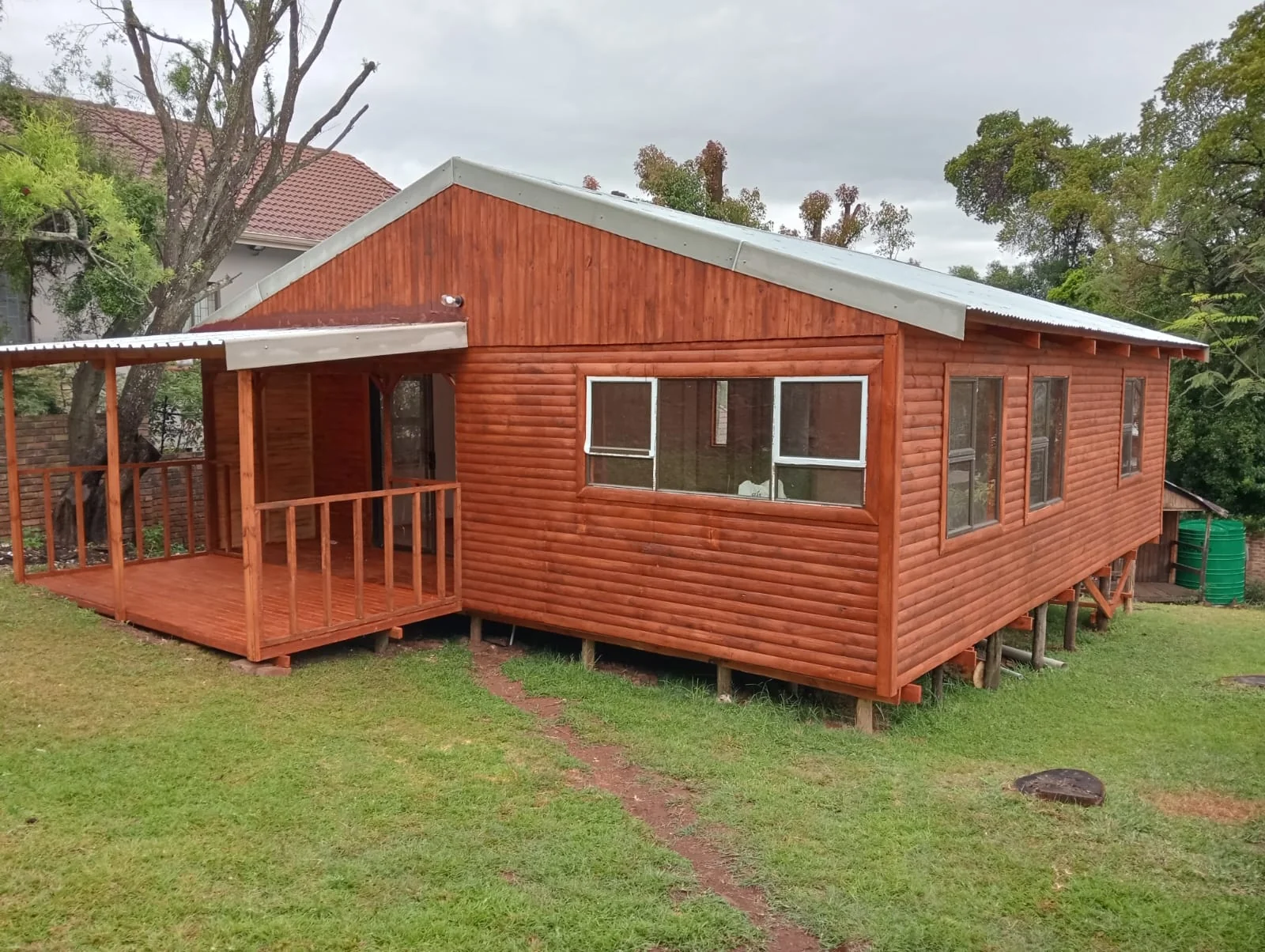 Wooden multi-room Wendy house with veranda